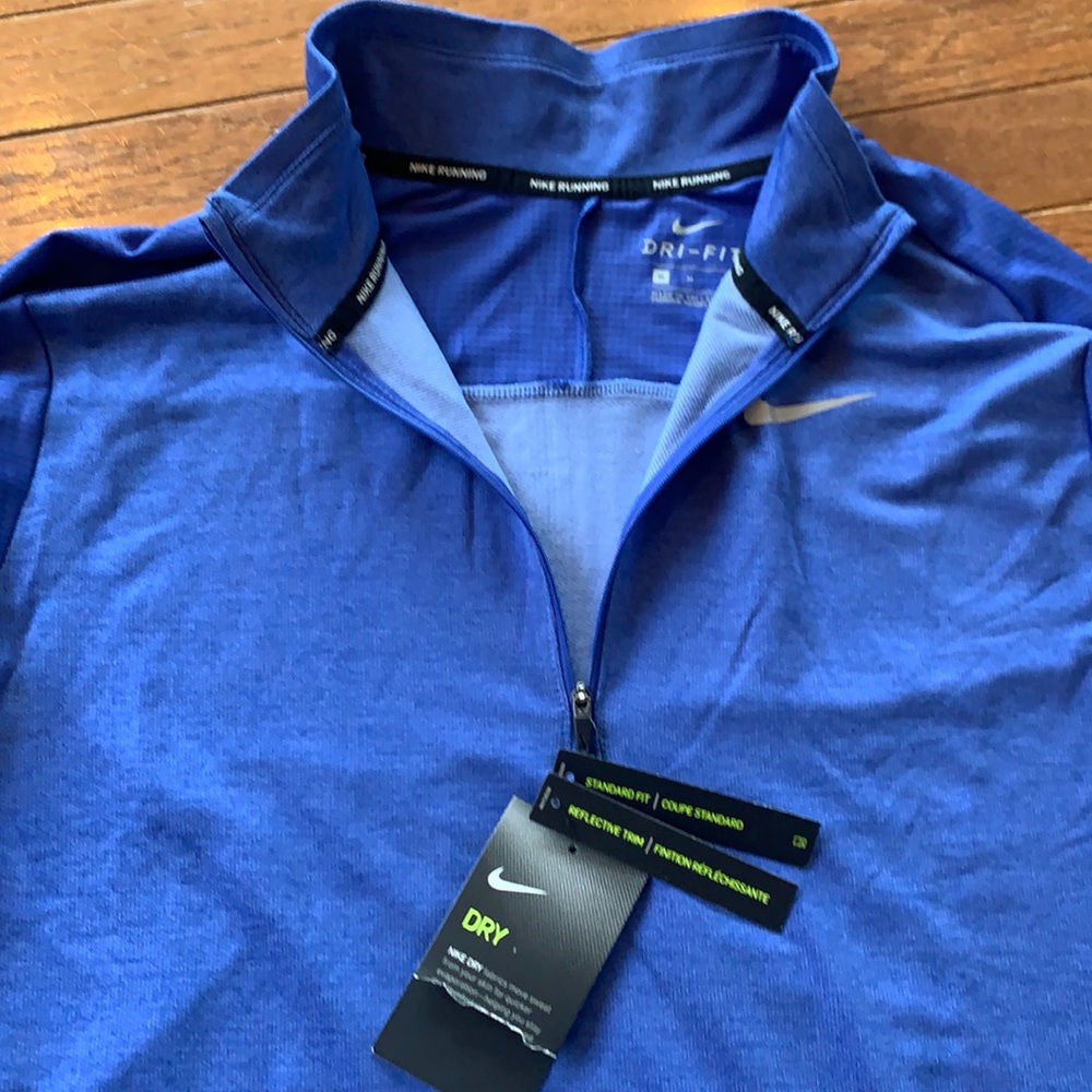 Nike 1/4 zip running Dri-fit top. Reflective trim.  New.  Size medium.